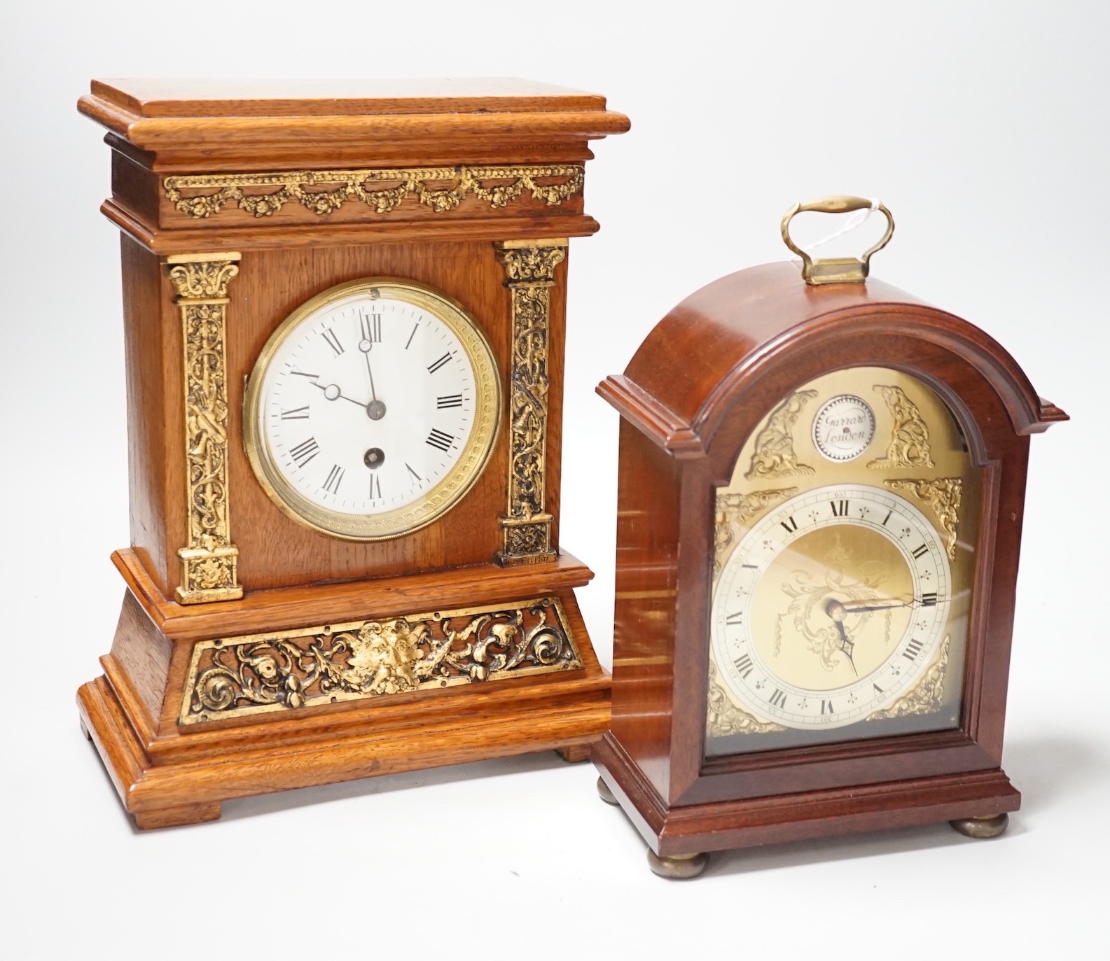 A Garrard clock and an oak brass mounted clock 29cms high